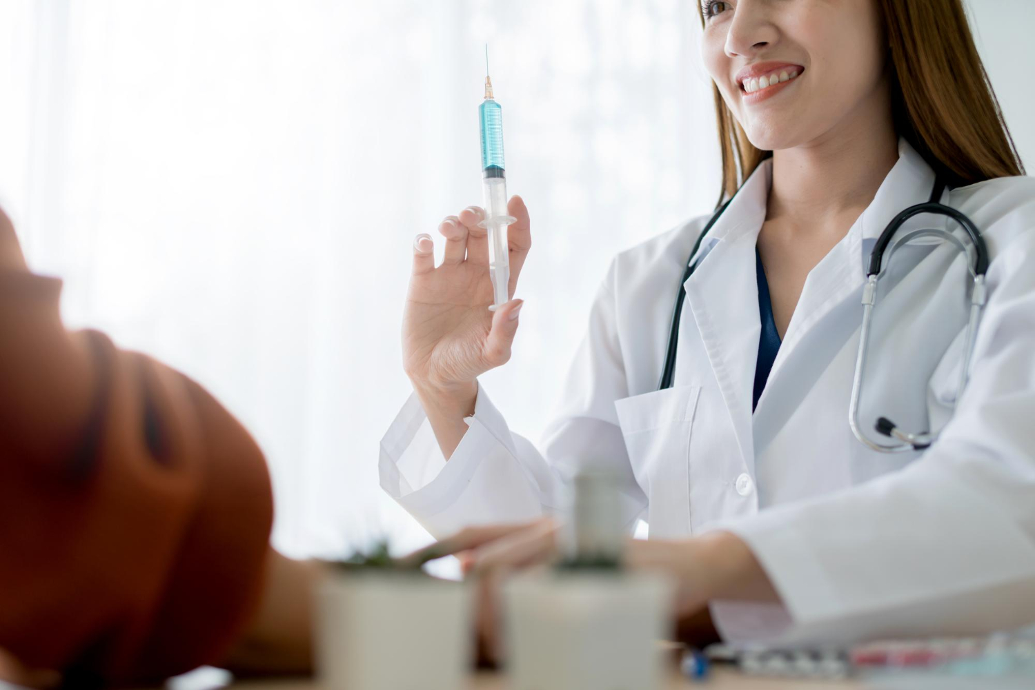 Asian doctor examine and injection serum to asian woman patient health ideas concept clinic hospital background