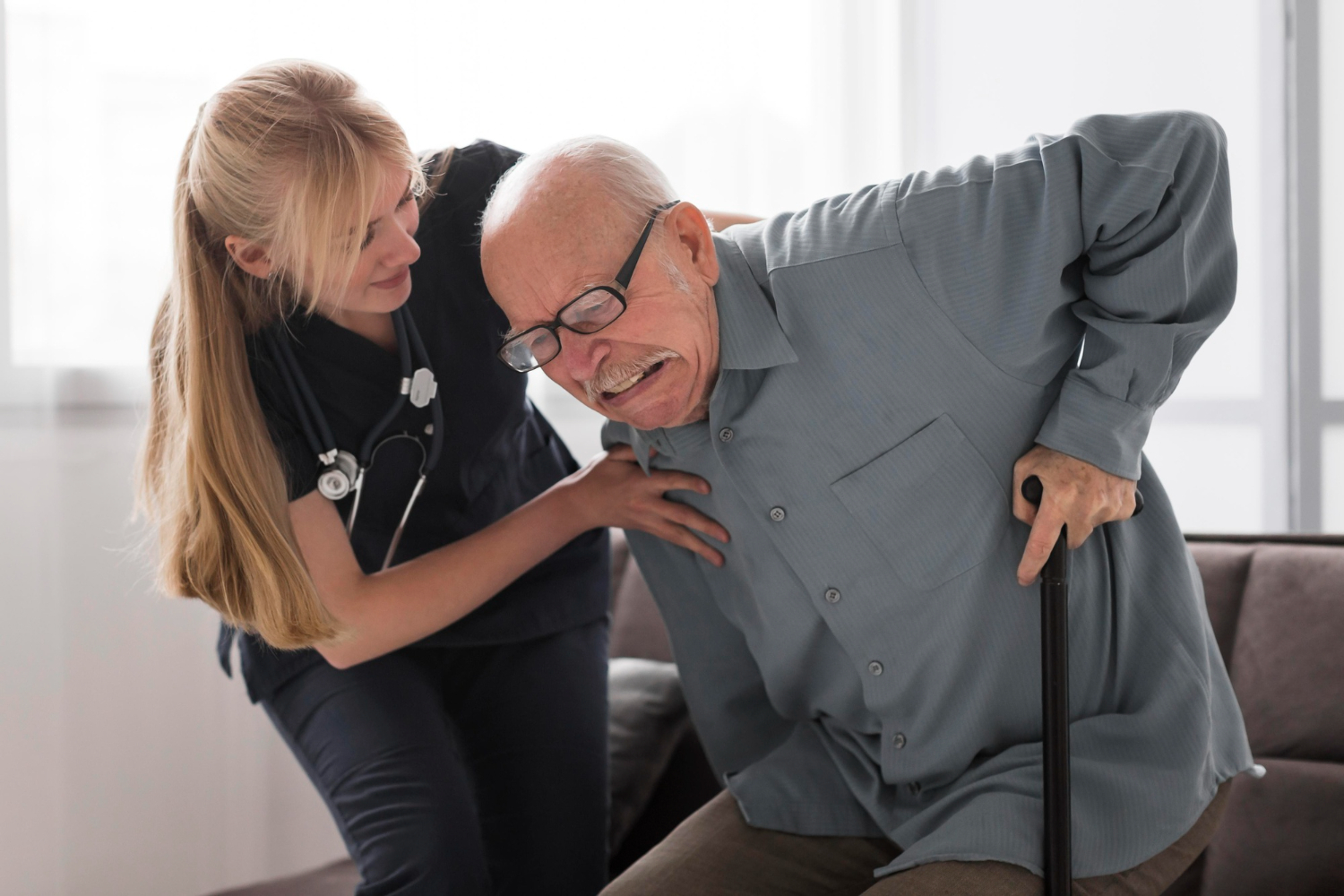 Old man in pain helped by nurse Old man in pain helped by nurse