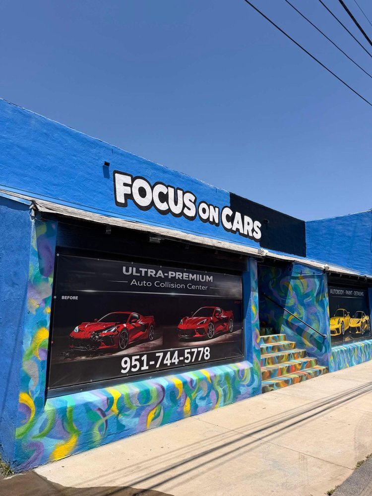 Collision repair technician working on a vehicle at Focus On Cars in San Bernardino, CA
