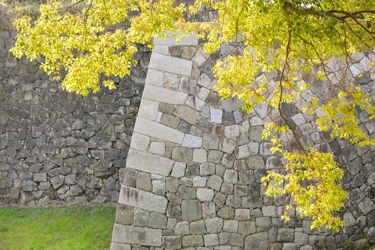 A sturdy, professionally constructed dry stone retaining wall, expertly built to enhance garden aesthetics by SGJ Landscaping in Honesdale, PA.