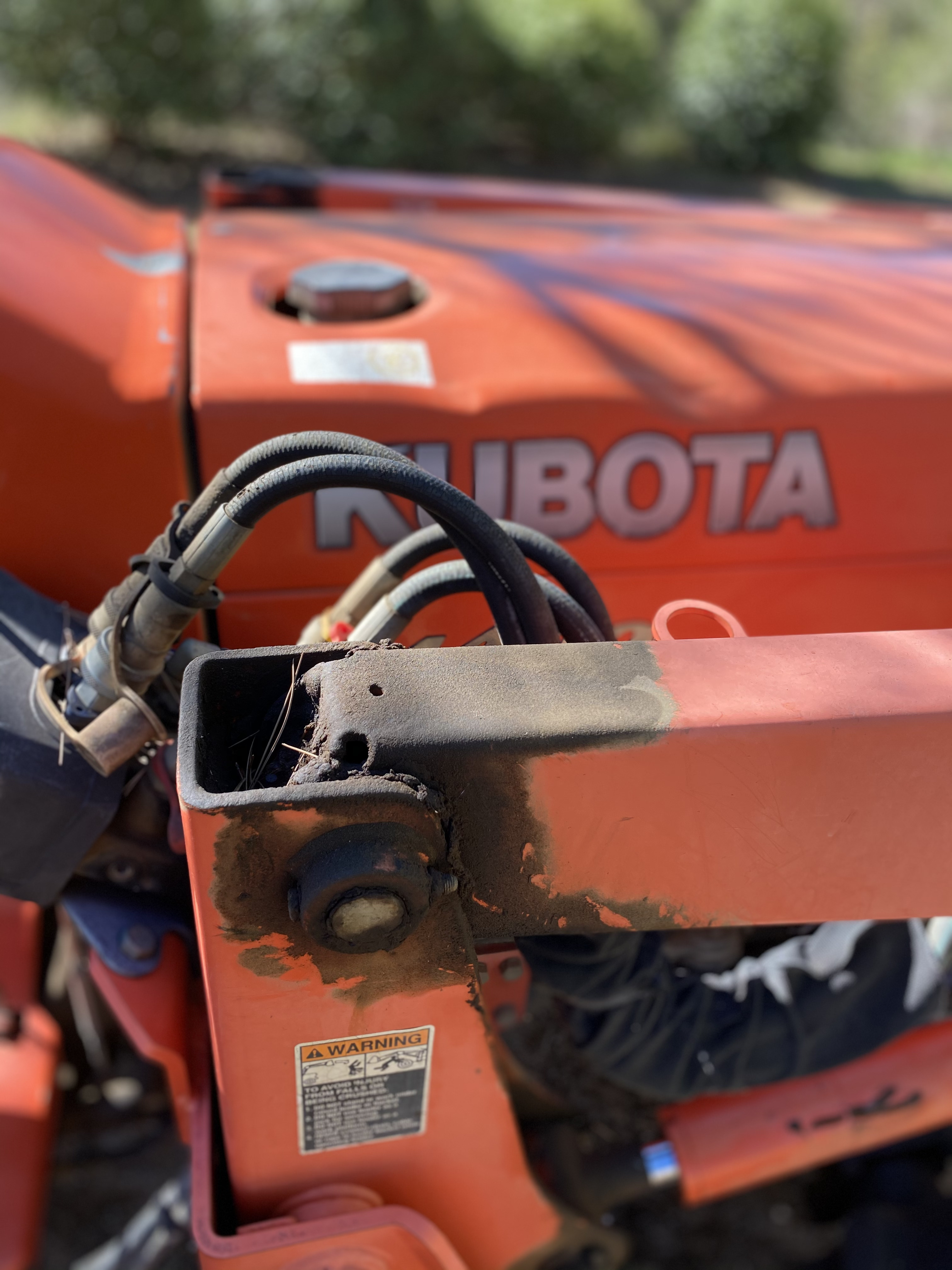 Close-up of Kubota tractor hydraulic repair work