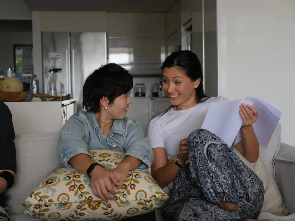 Two participants in conversation sharing notes