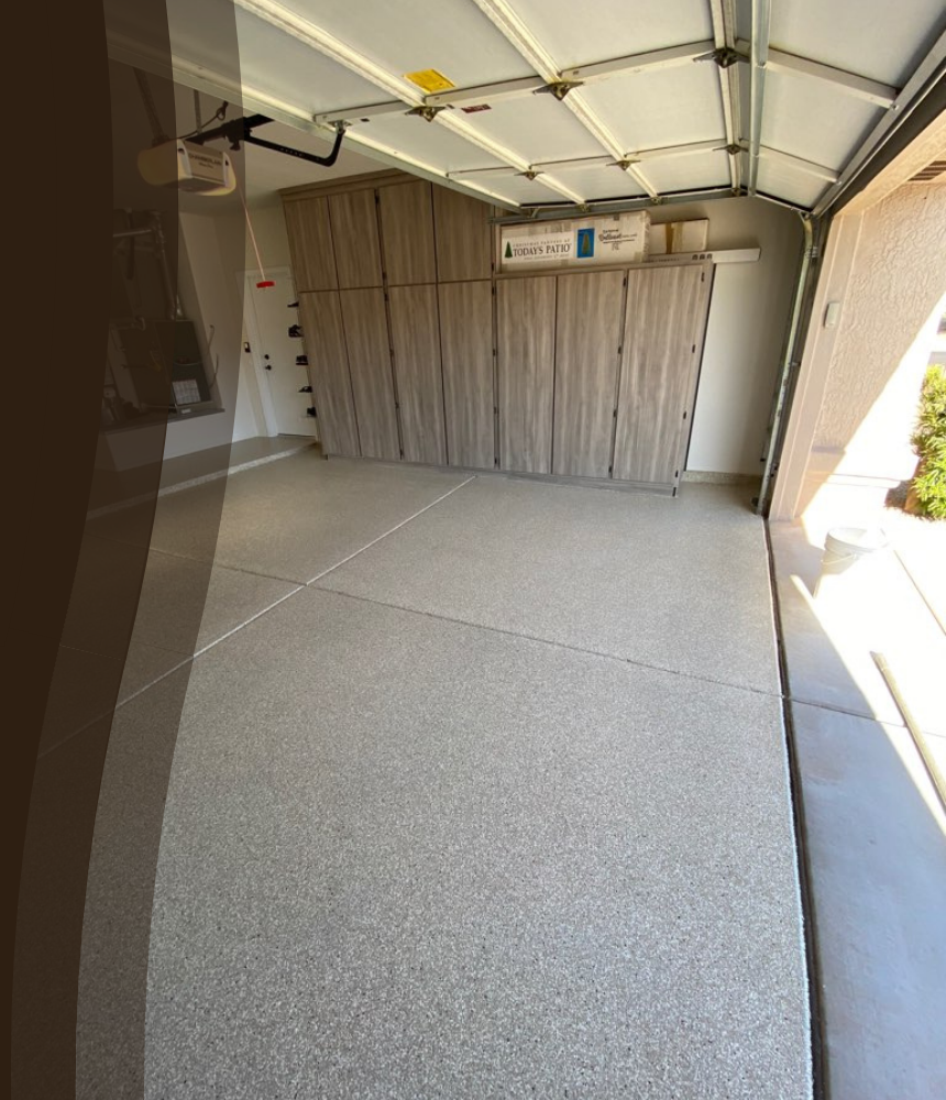 Epoxy flooring technician applying a smooth base coat to a commercial concrete surface during a floor coating installation.