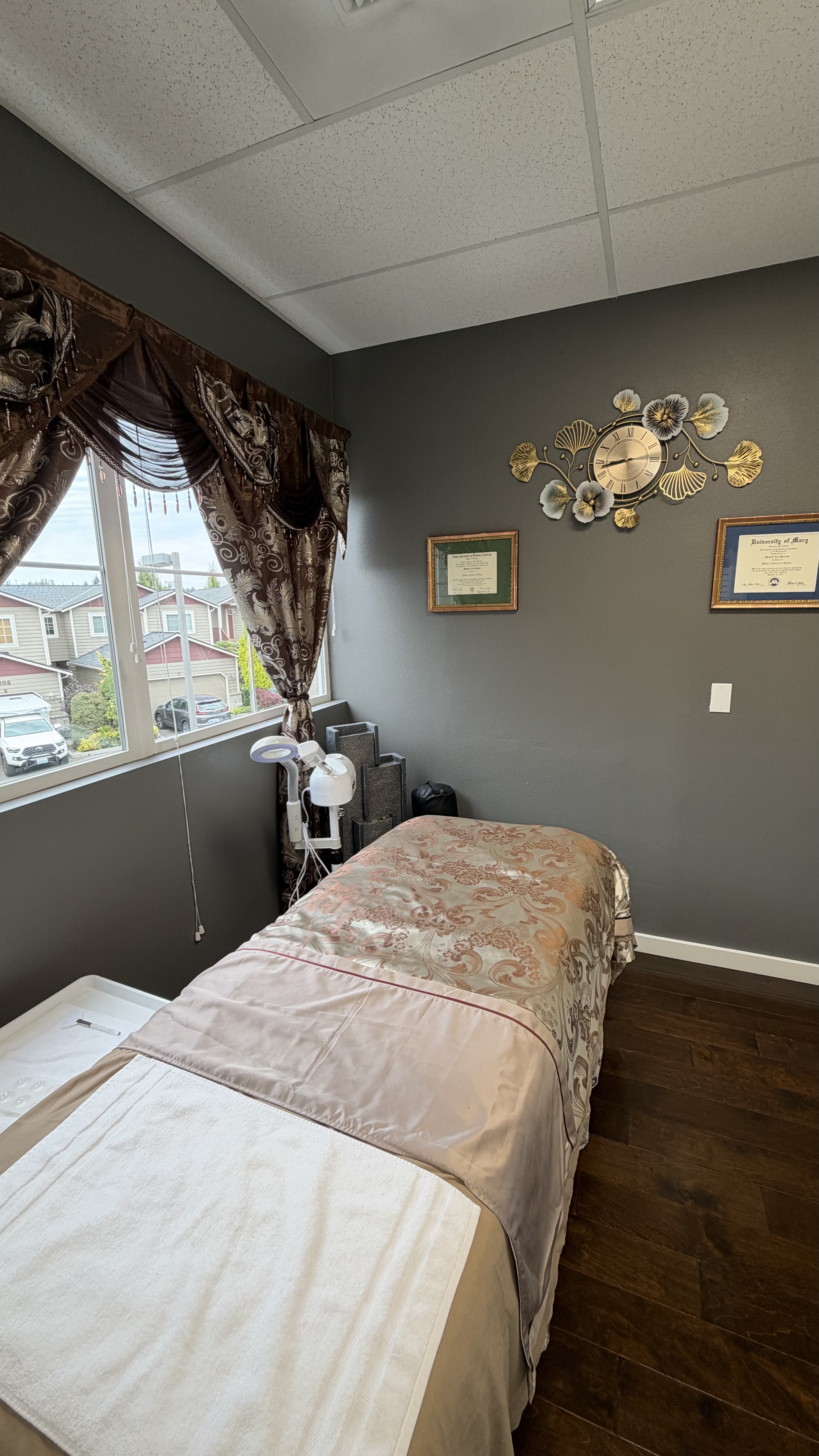 Chez Michelle treatment room beside a curtained window.