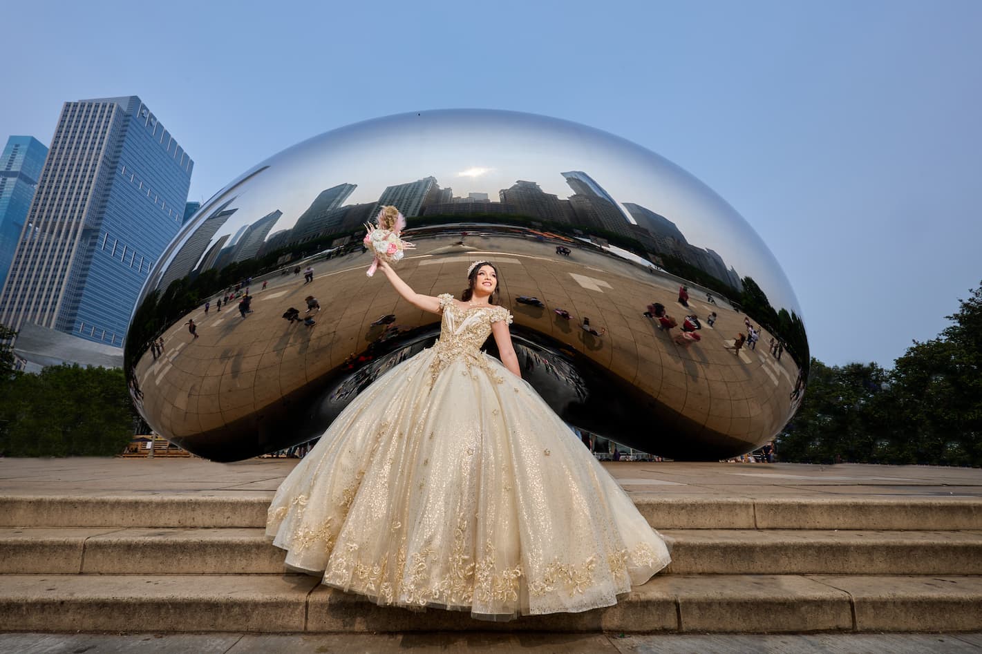 A woman standing in front of a counter holding a cell phone