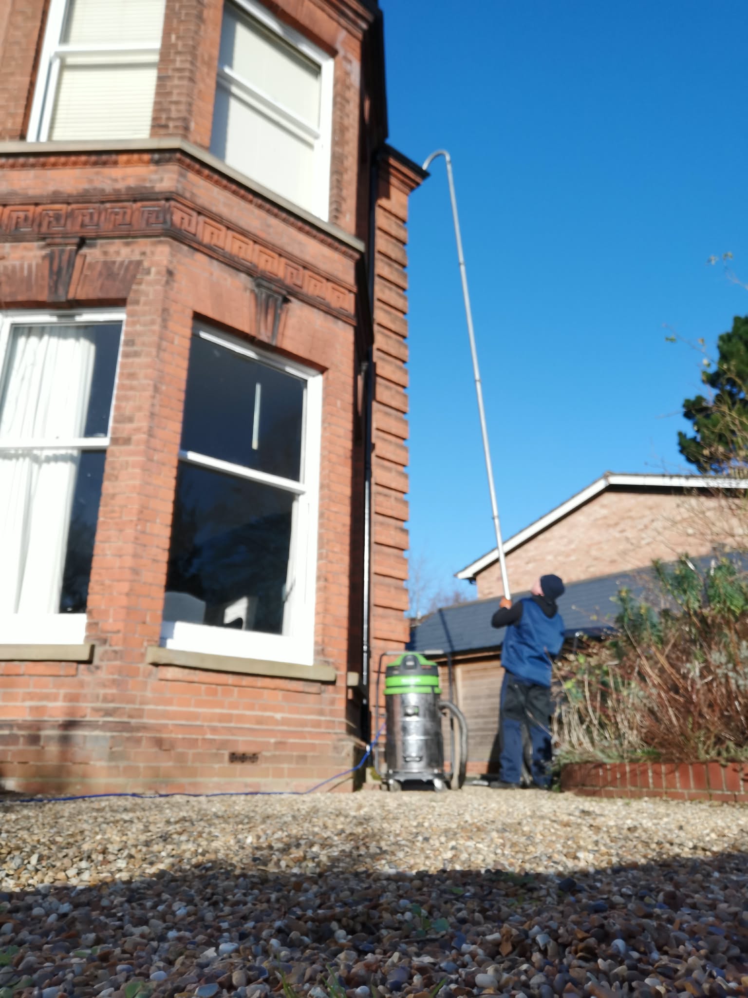 Period house having its gutters cleaned