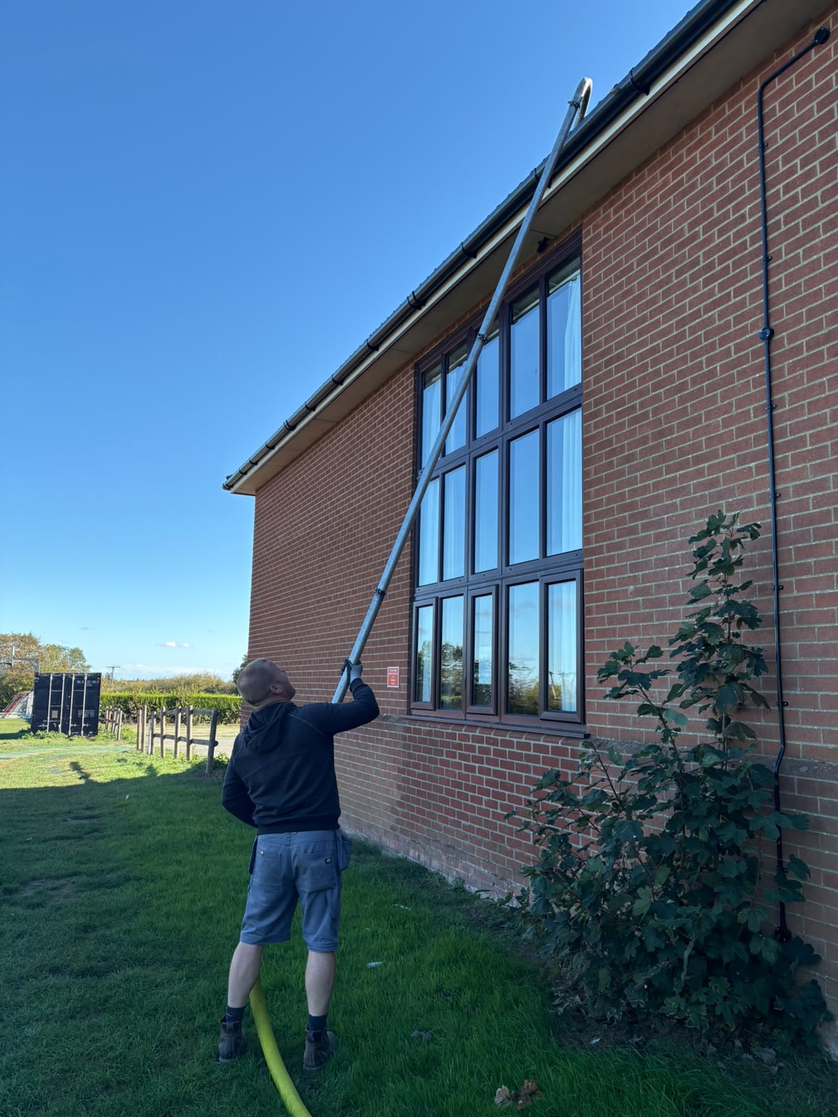 Commercial gutter cleaning with a high-reach vacuum