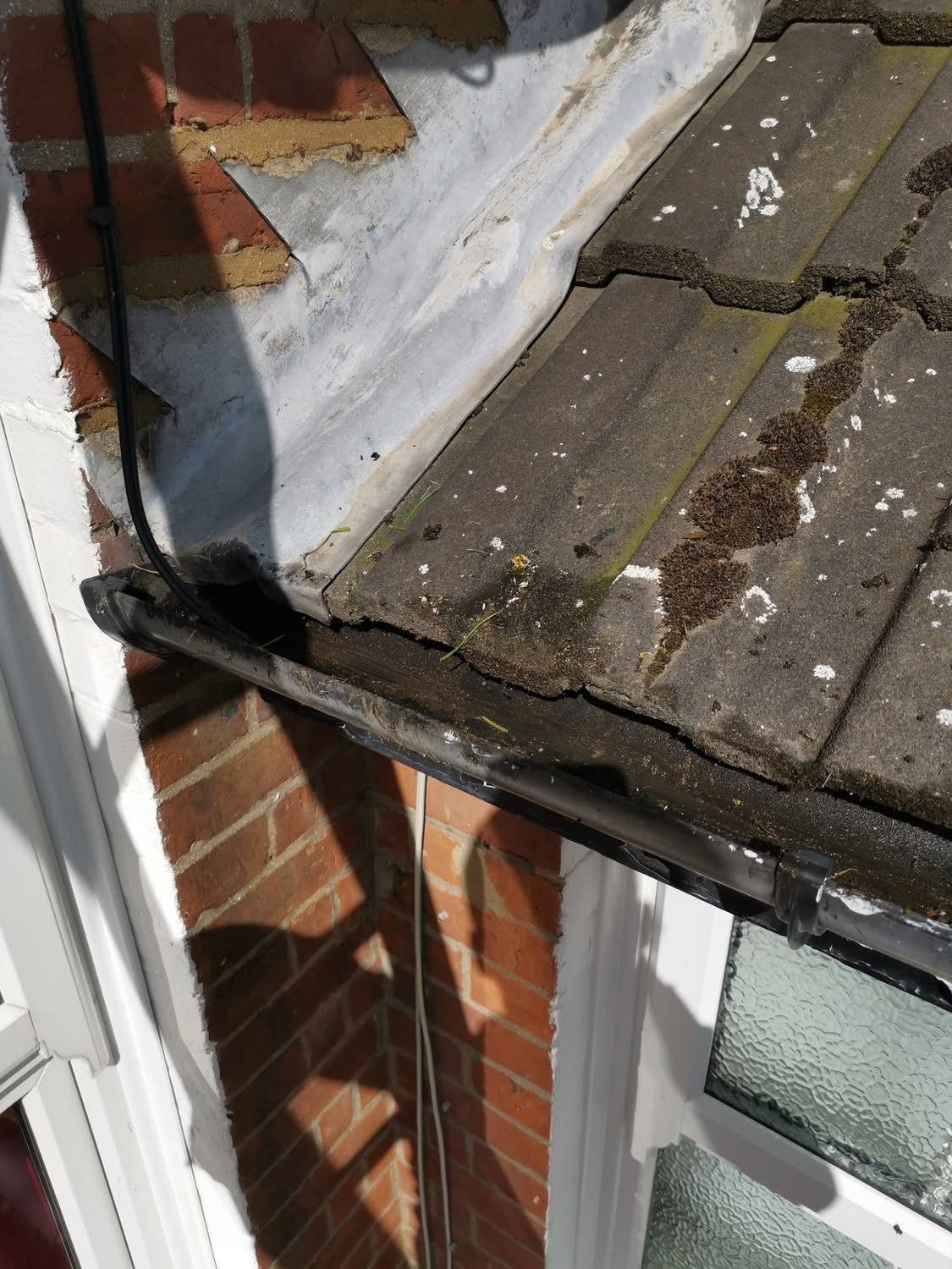 The same bay window gutter cleared after cleaning