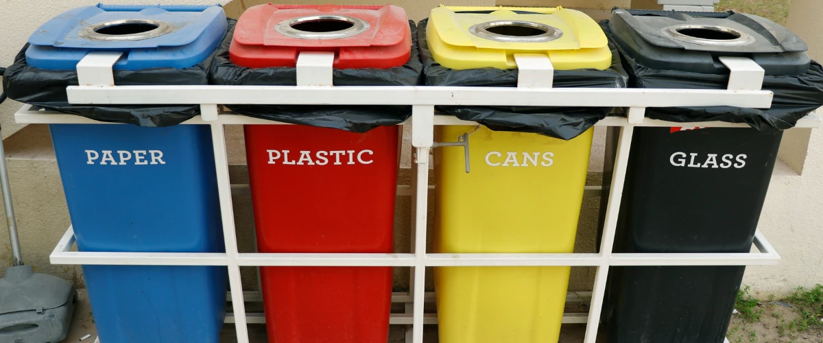 Recycling bins labeled paper plastic cans and glass for waste sorting Recycling bins labeled paper plastic cans and glass for waste sorting