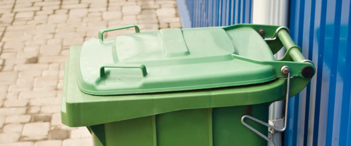 Green wheelie bin used for household waste collection