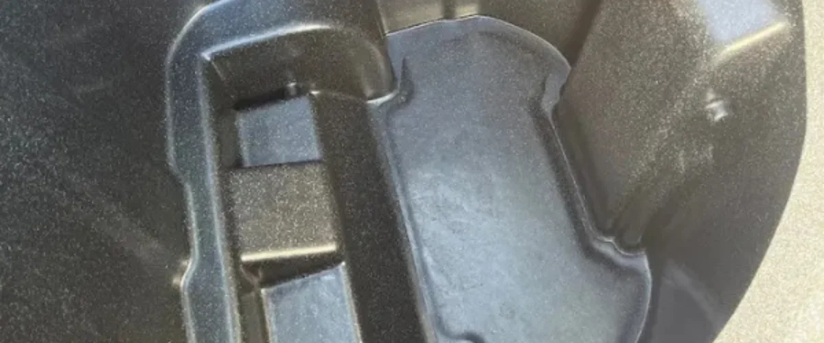 A close-up, abstract shot of dark, textured machine parts with subtle reflections and varying depths. A close-up, abstract shot of dark, textured machine parts with subtle reflections and varying depths.