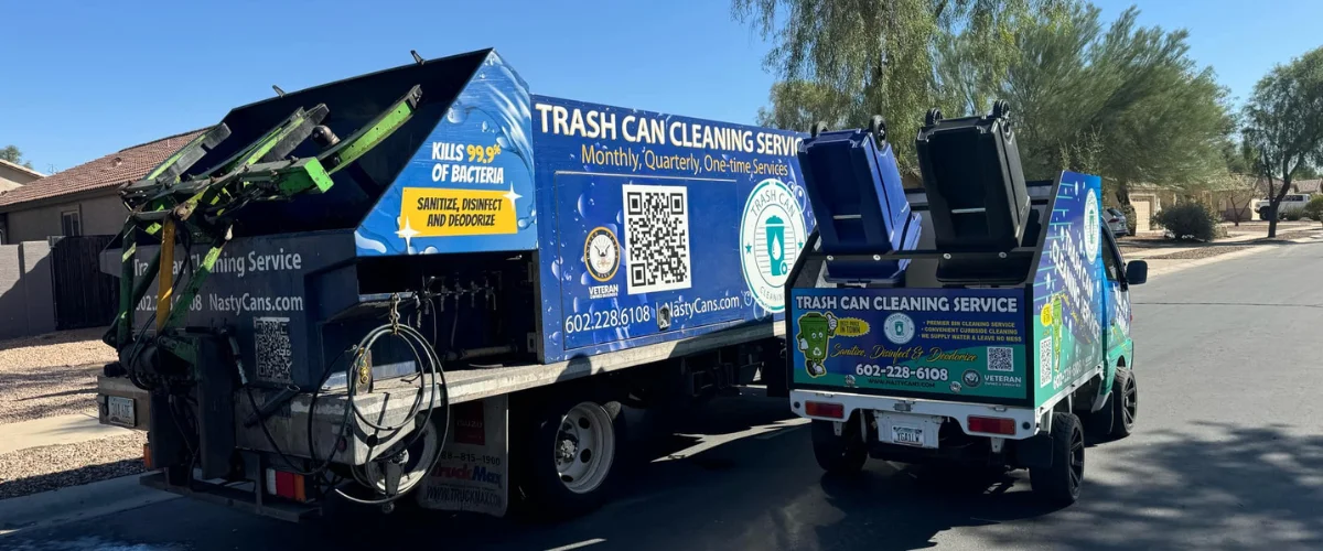 A truck with "Trash Can Cleaning Service" branding on the side, actively cleaning a trash bin on a street.