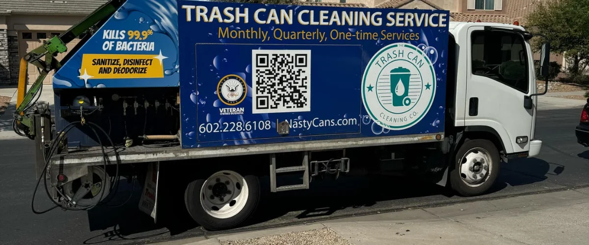 Two blue and green trash can cleaning service trucks with branding and QR codes parked on a sunny day.