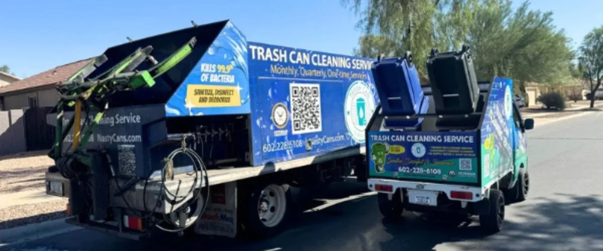 A blue and green Nasty Cans trash can cleaning service truck parked on a street in a residential area. A blue and green Nasty Cans trash can cleaning service truck parked on a street in a residential area.