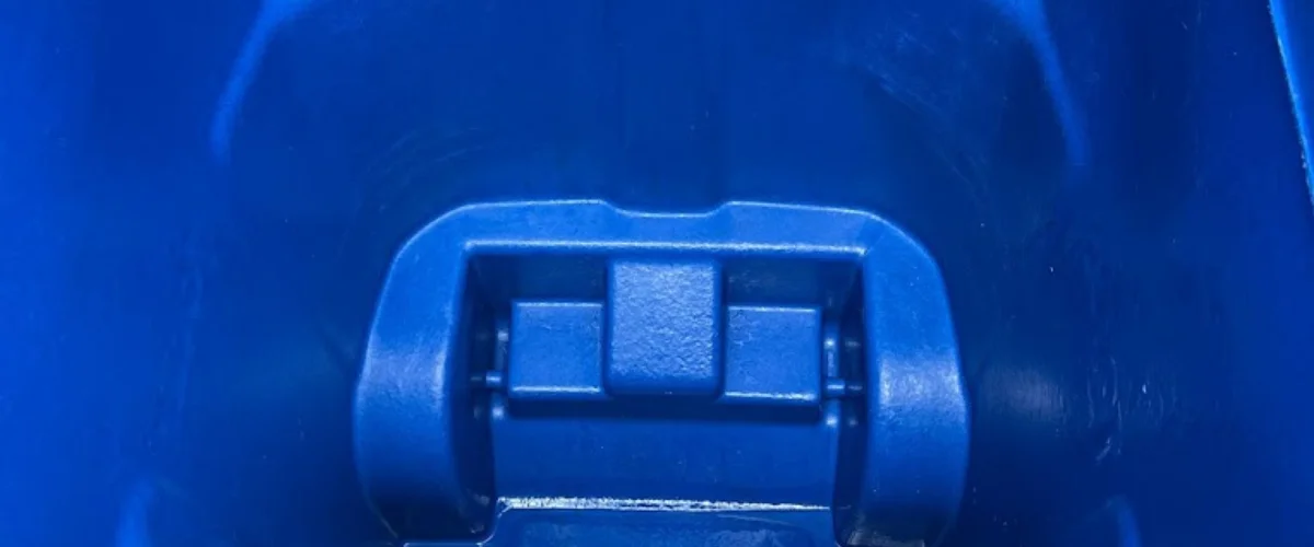 A close-up, centered view of a durable blue plastic hinge mechanism within a larger blue container.