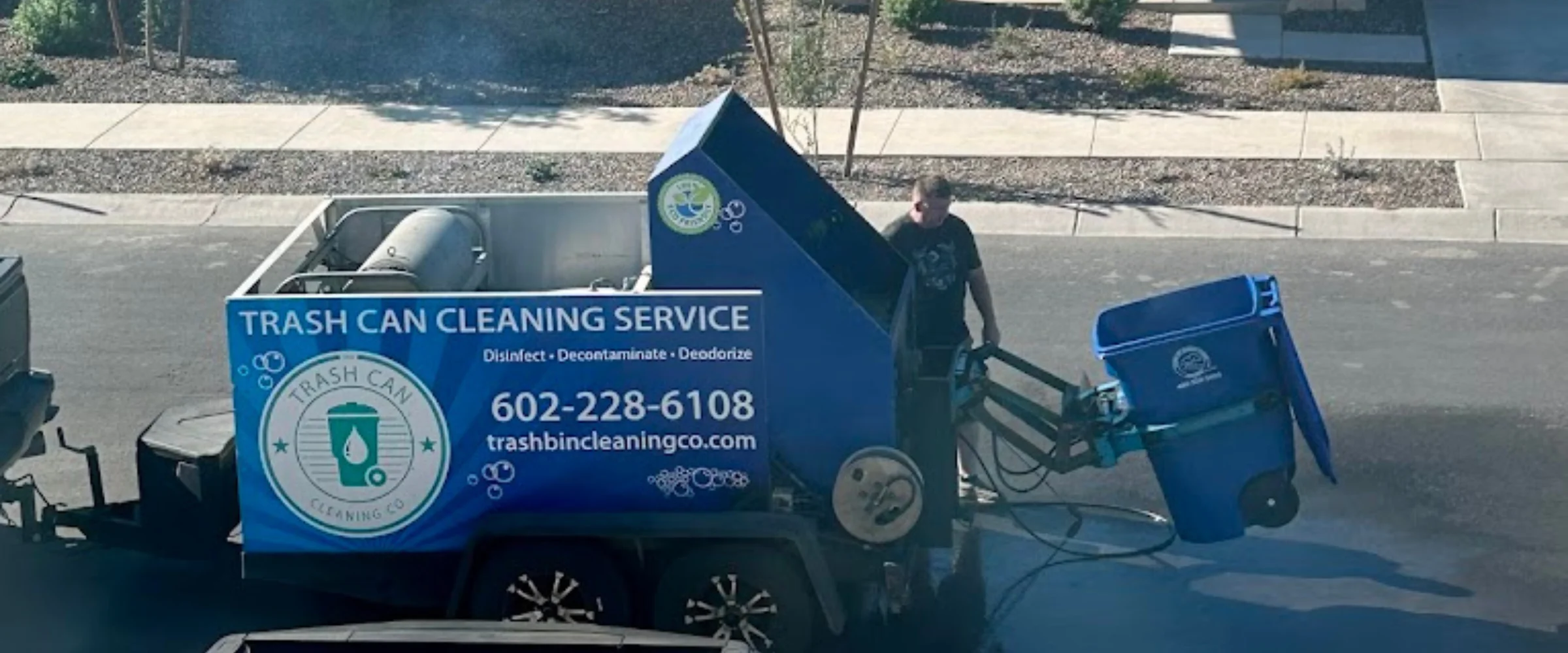 Side view of a blue and green truck for 'Trash Can Cleaning Service', branded 'Nasty Cans' and 'The Trash Can Cleaning Co.' Side view of a blue and green truck for 'Trash Can Cleaning Service', branded 'Nasty Cans' and 'The Trash Can Cleaning Co.'
