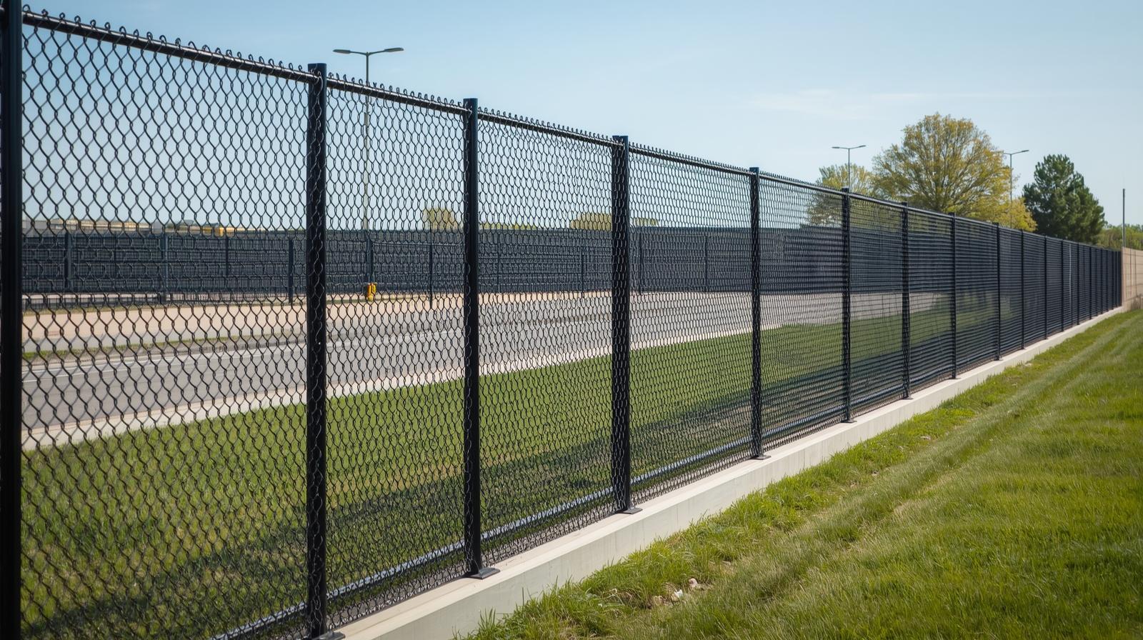 Commercial chain link fence installation in Beloit WI around business property for security and perimeter control. Commercial chain link fence installation in Beloit WI around business property for security and perimeter control.
