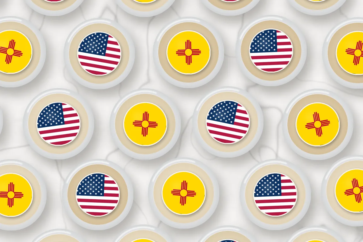 Cocktails topped with edible drink toppers printed with the New Mexico flag and the American flag