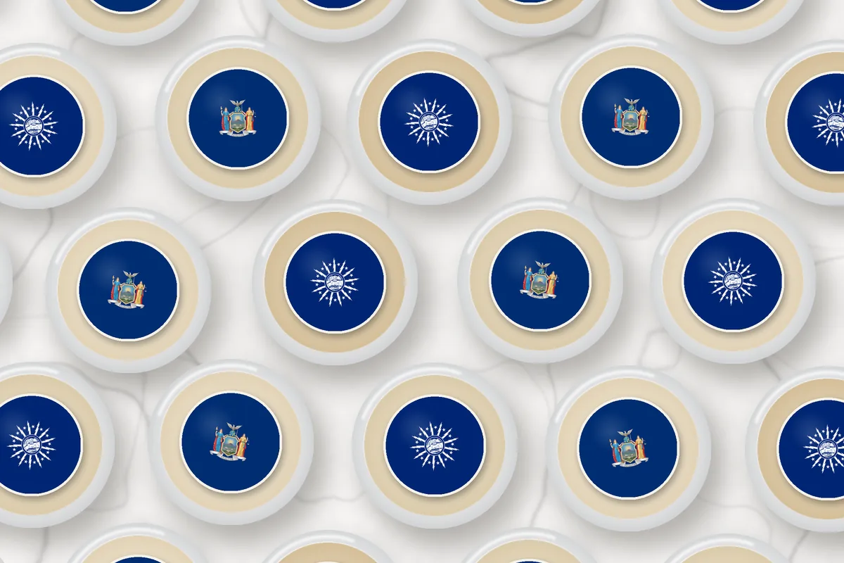 Cocktails topped with edible drink toppers printed with the Buffalo city flag and the New York flag