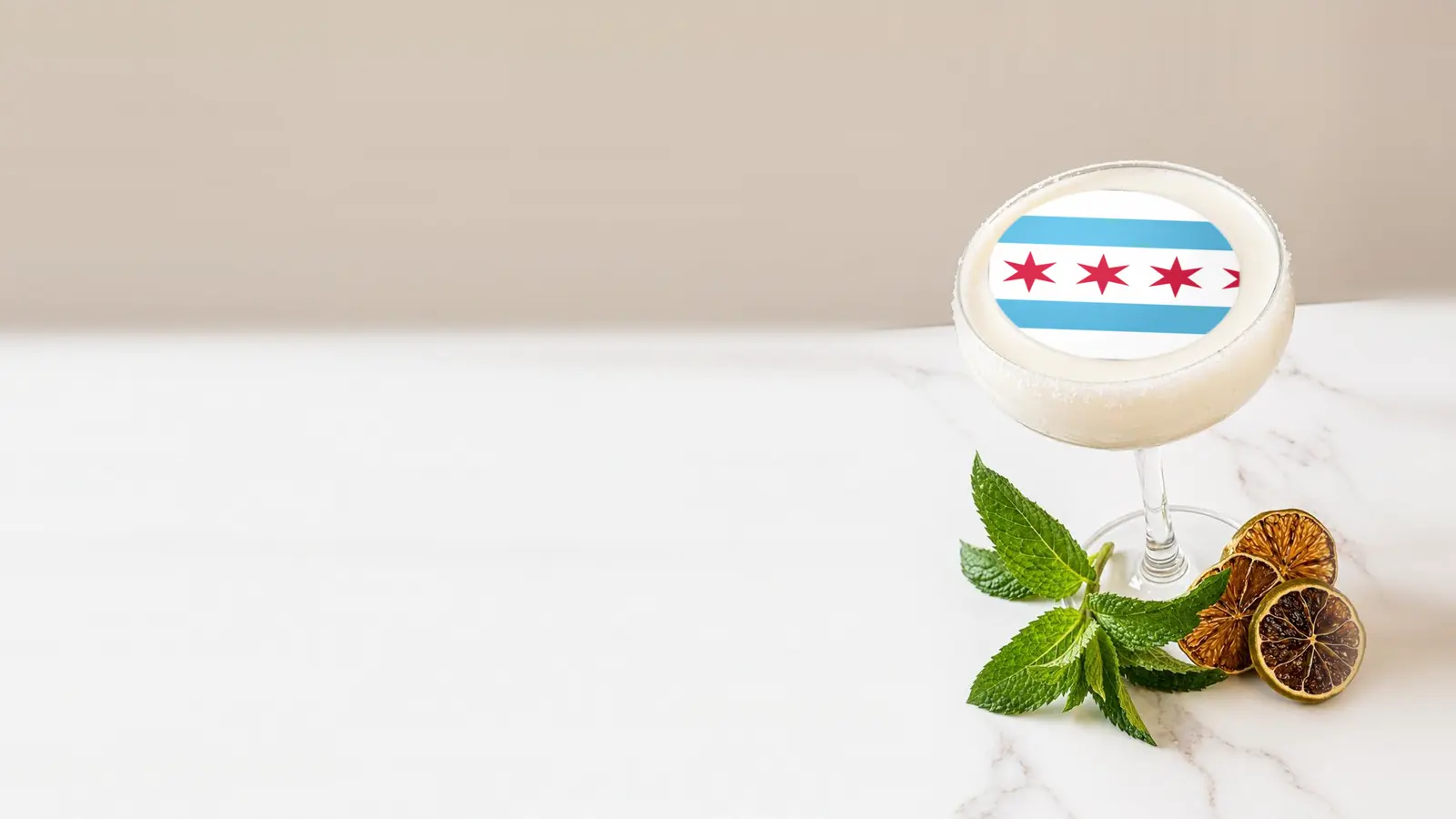 Coupe cocktail topped with a round edible frosting sheet topper printed with the Chicago city flag