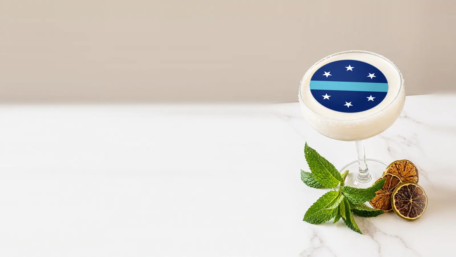 Coupe cocktail topped with a round edible frosting sheet topper printed with the Anaheim city flag