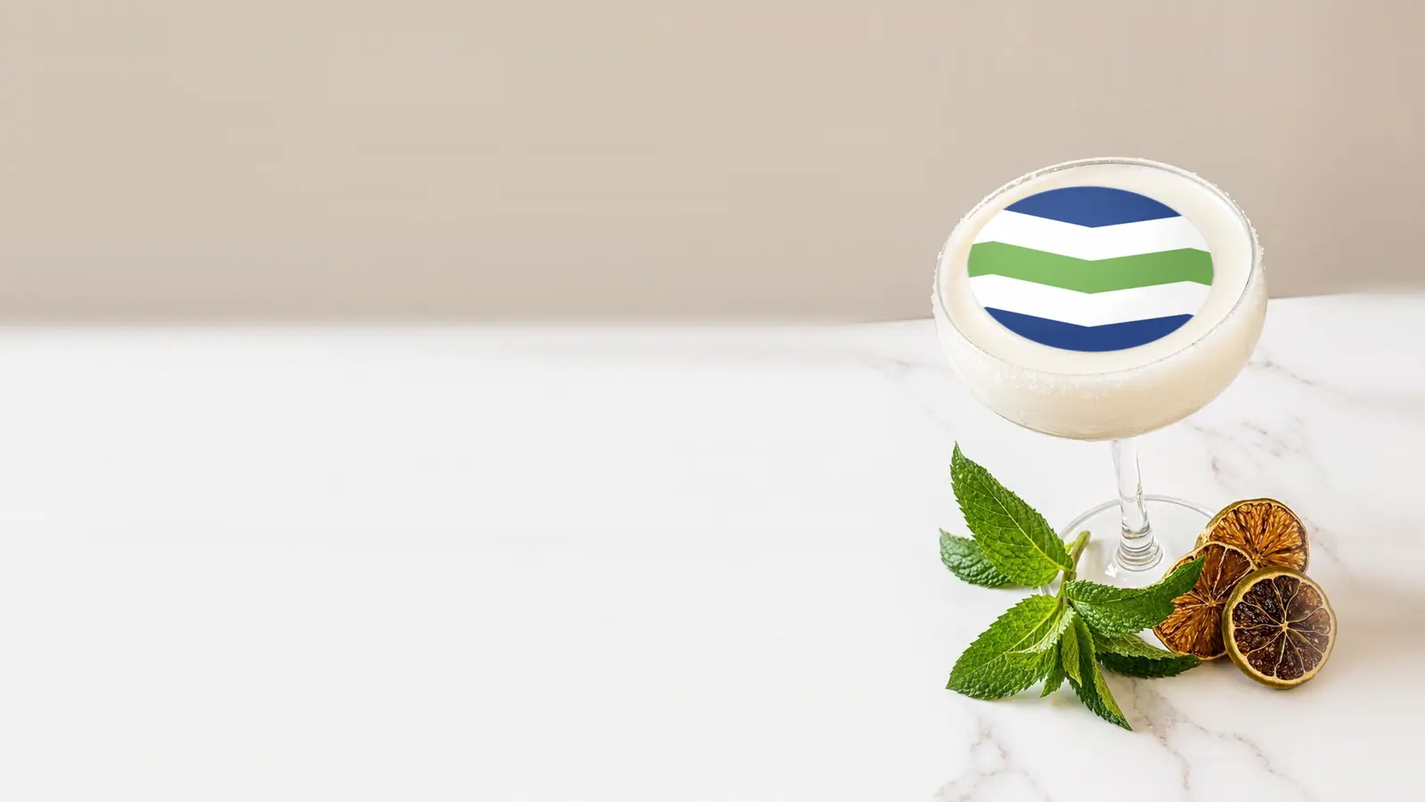 Coupe cocktail topped with a round edible frosting sheet topper printed with the Burlington city flag