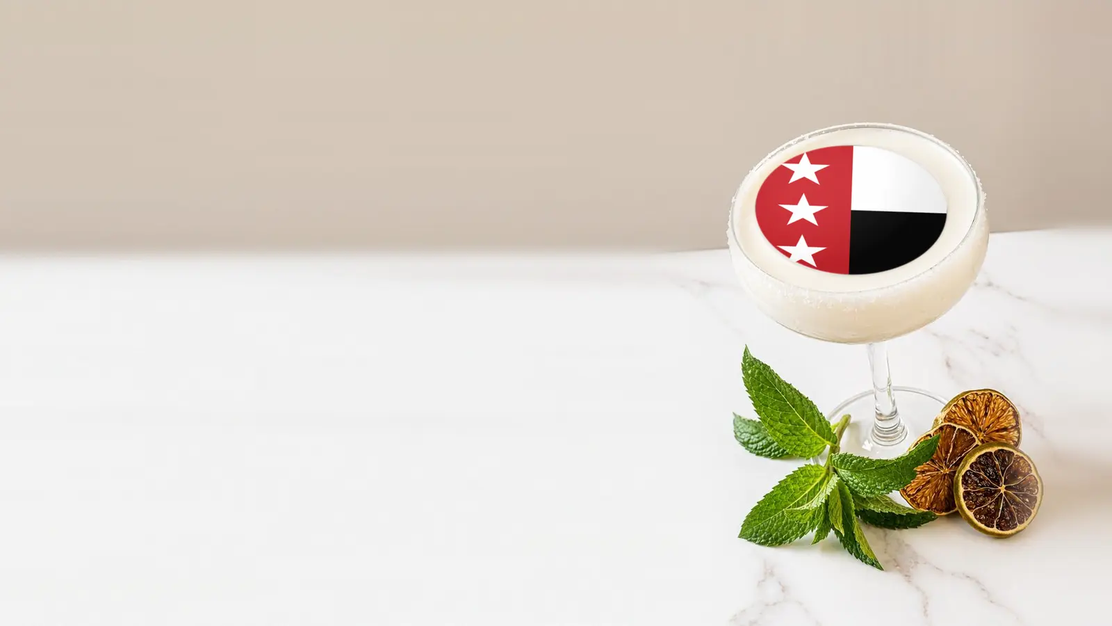 Coupe cocktail topped with a round edible frosting sheet topper printed with the Laredo city flag