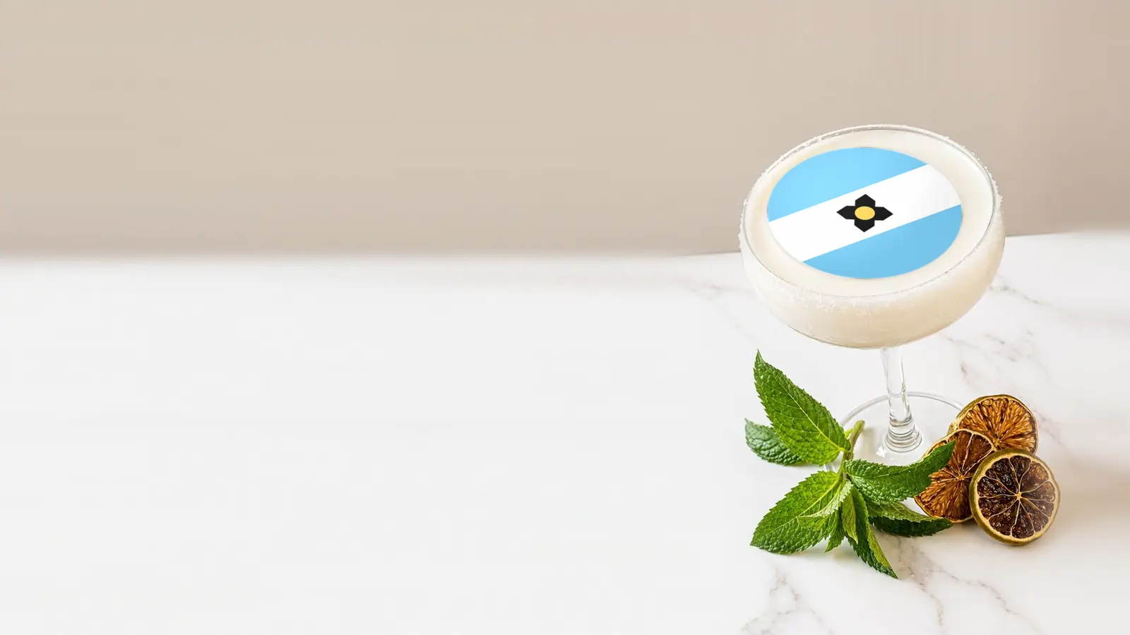 Coupe cocktail topped with a round edible frosting sheet topper printed with the Madison city flag