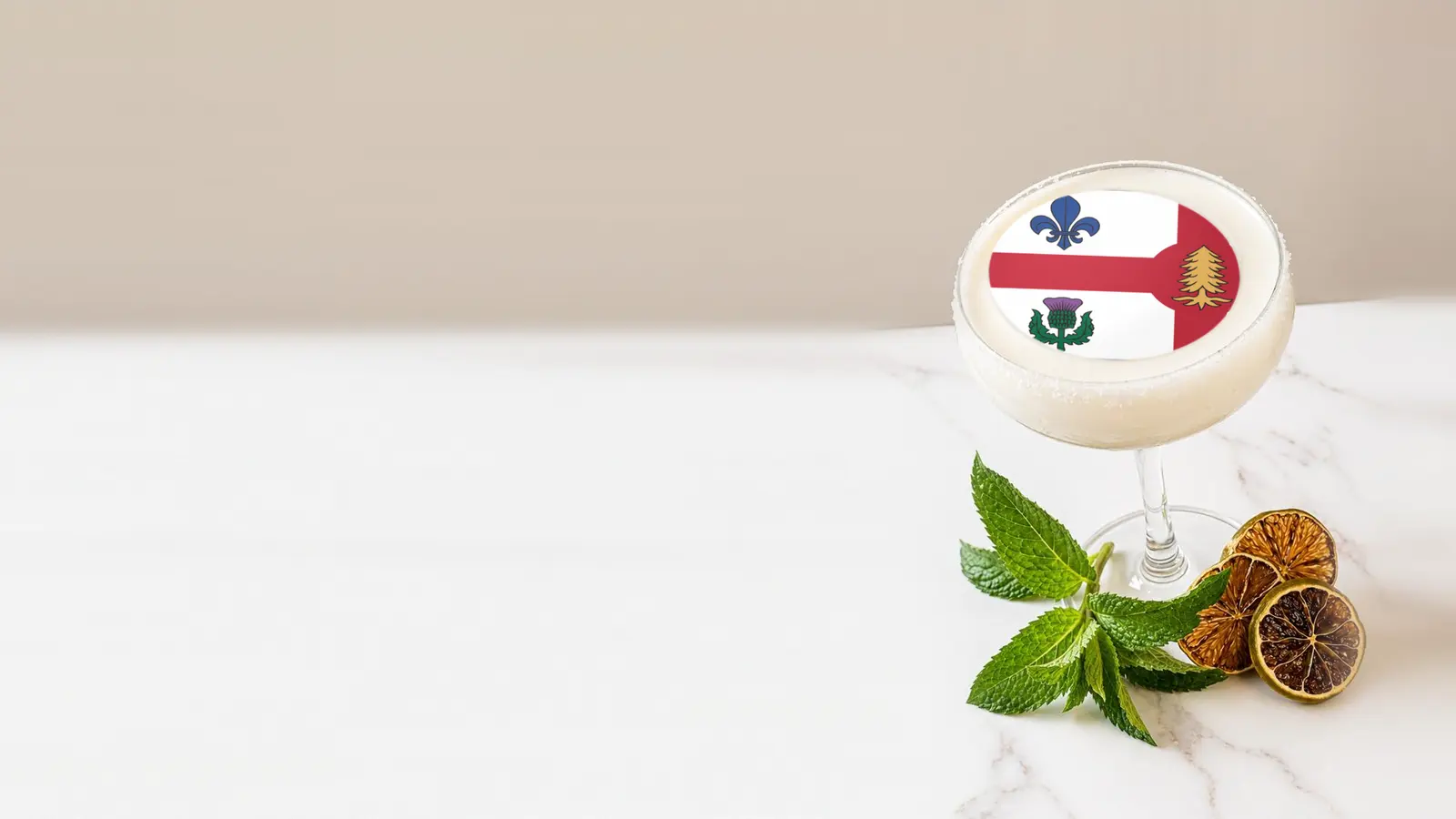Coupe cocktail topped with a round edible frosting sheet topper printed with the Montreal city flag