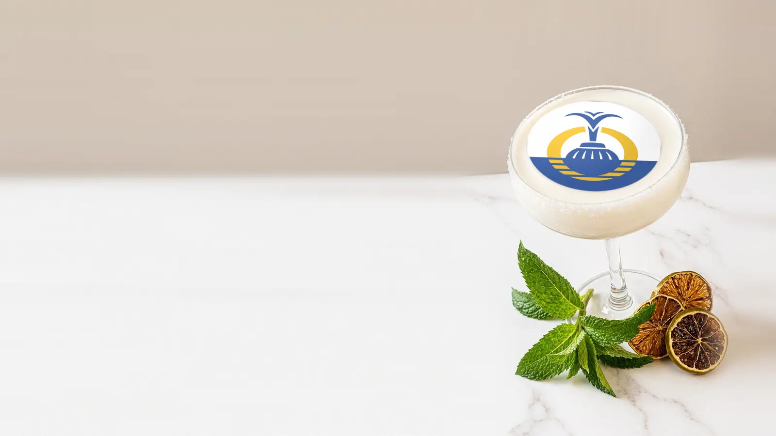 Coupe cocktail topped with a round edible frosting sheet topper printed with the Orlando city flag