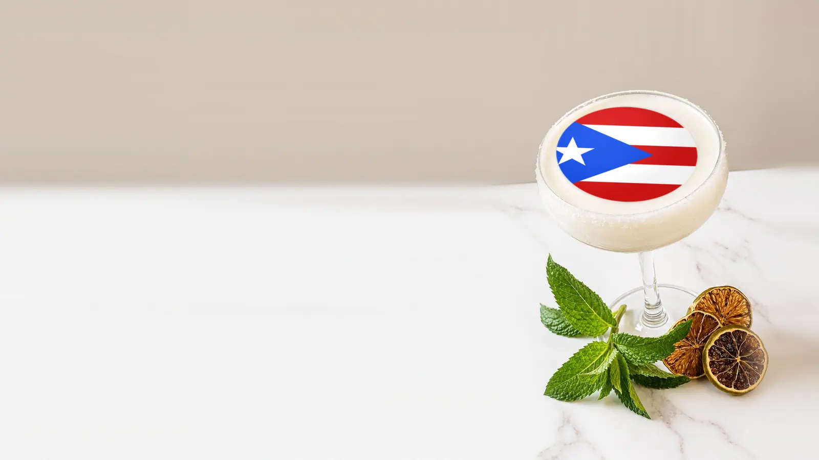 Coupe cocktail topped with a round edible frosting sheet topper printed with the flag of Puerto Rico