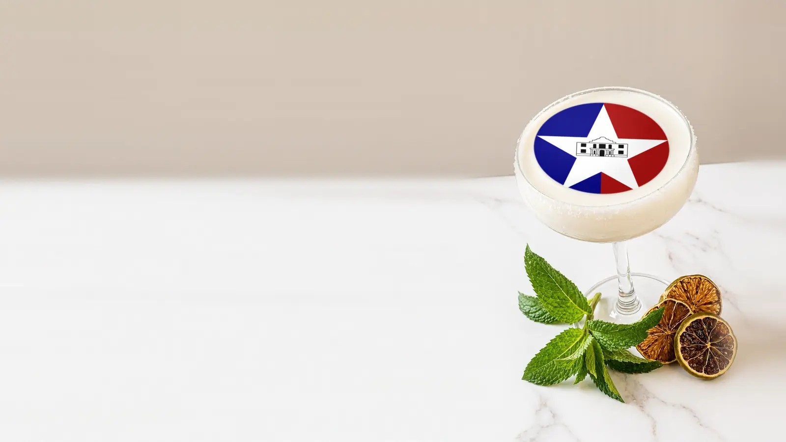 Coupe cocktail topped with a round edible frosting sheet topper printed with the San Antonio city flag