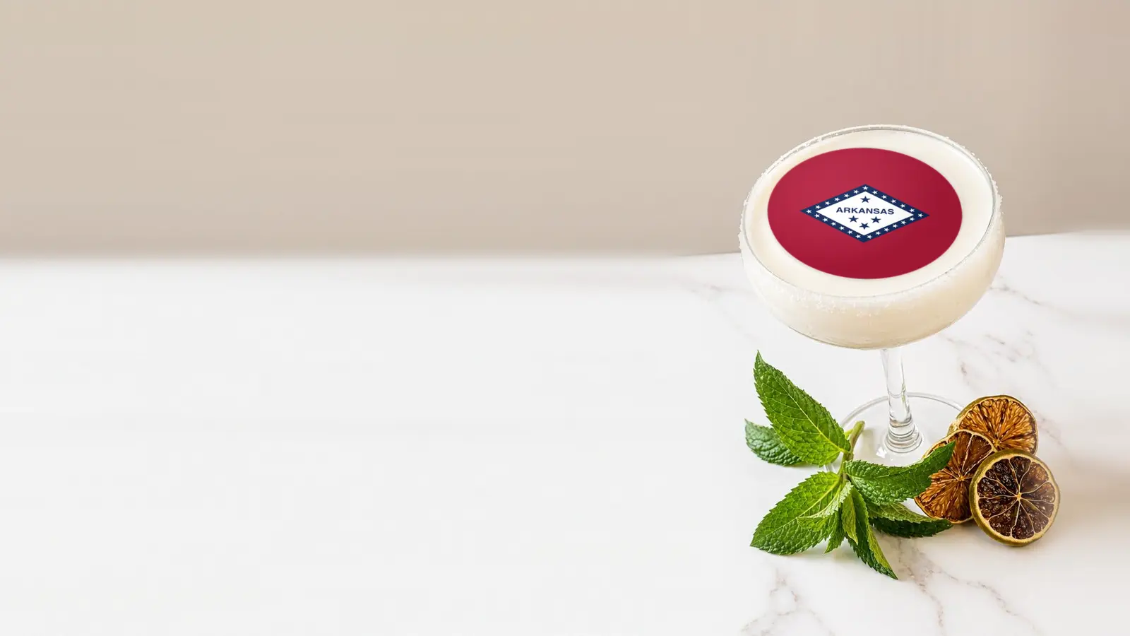 Coupe cocktail topped with a round edible frosting sheet topper printed with the Arkansas state flag