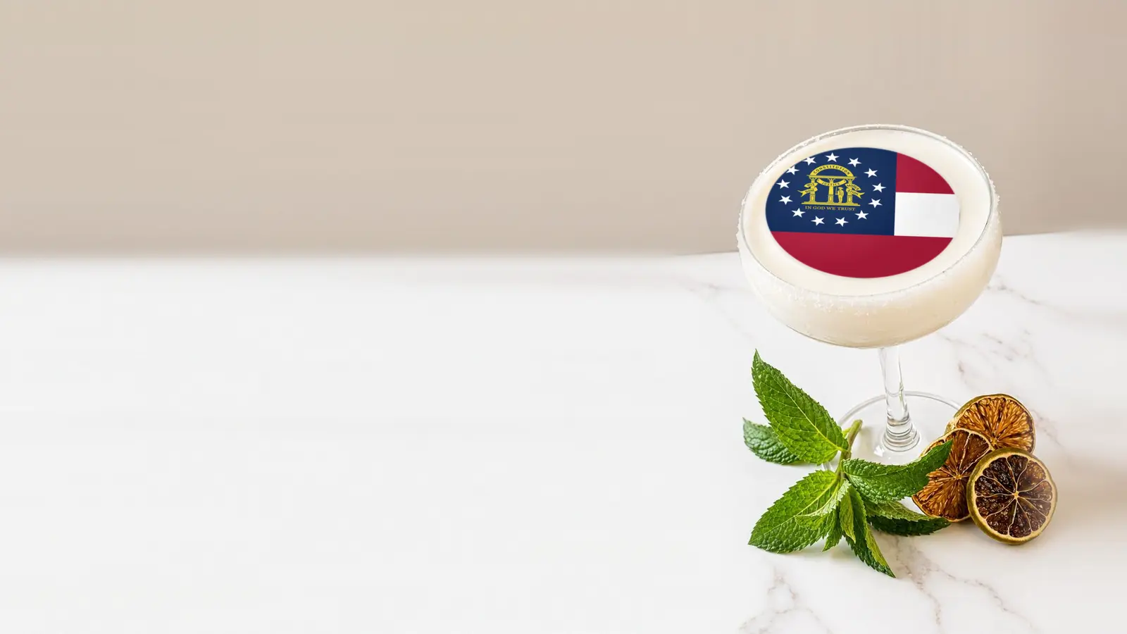 Coupe cocktail topped with a round edible frosting sheet topper printed with the Georgia state flag