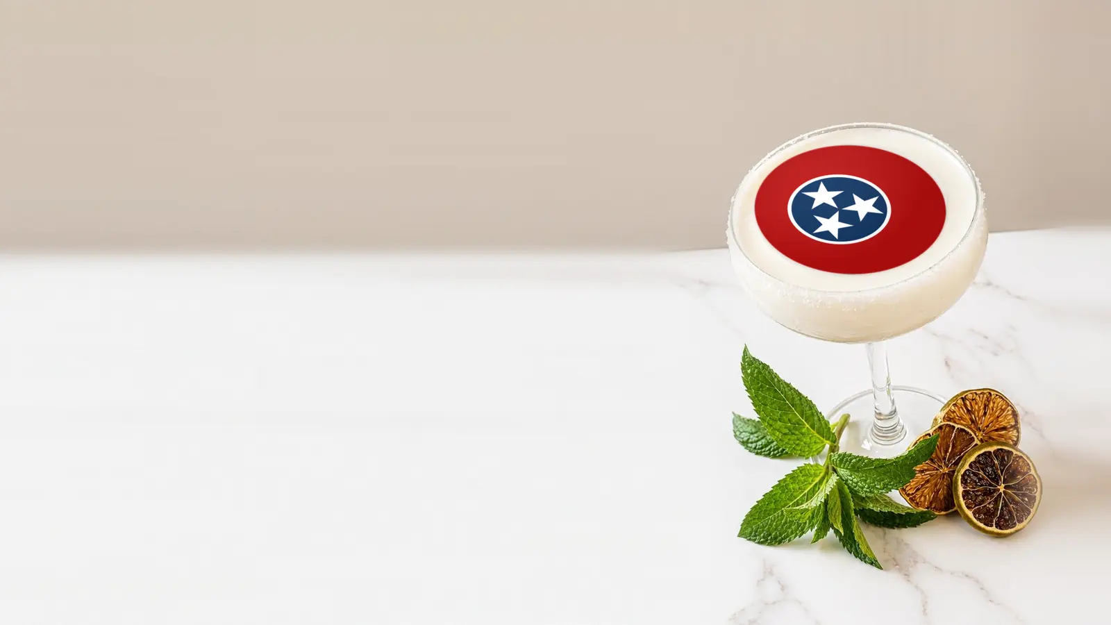 Coupe cocktail topped with a round edible frosting sheet topper printed with the Tennessee state flag