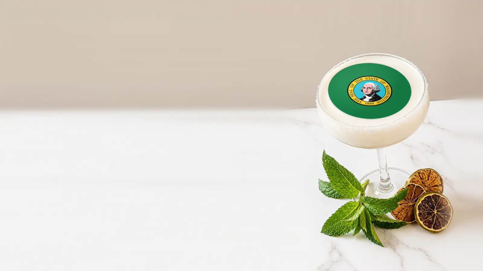 Coupe cocktail topped with a round edible frosting sheet topper printed with the Washington state flag