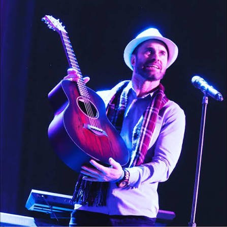 Ryan Brolliar performing with a guitar