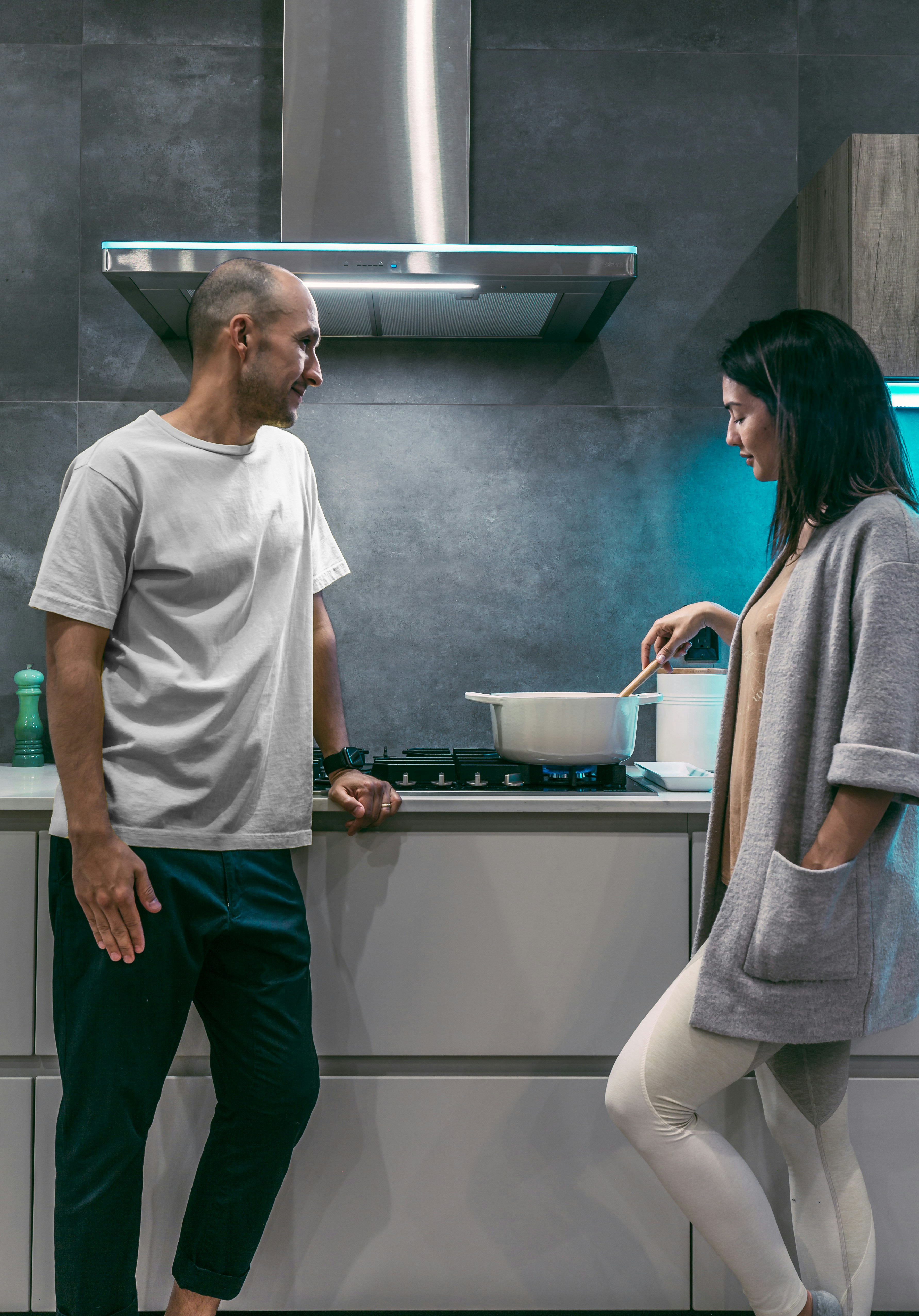 A couple at the kitchen, having a conversation while making dinner. A couple at the kitchen, having a conversation while making dinner.