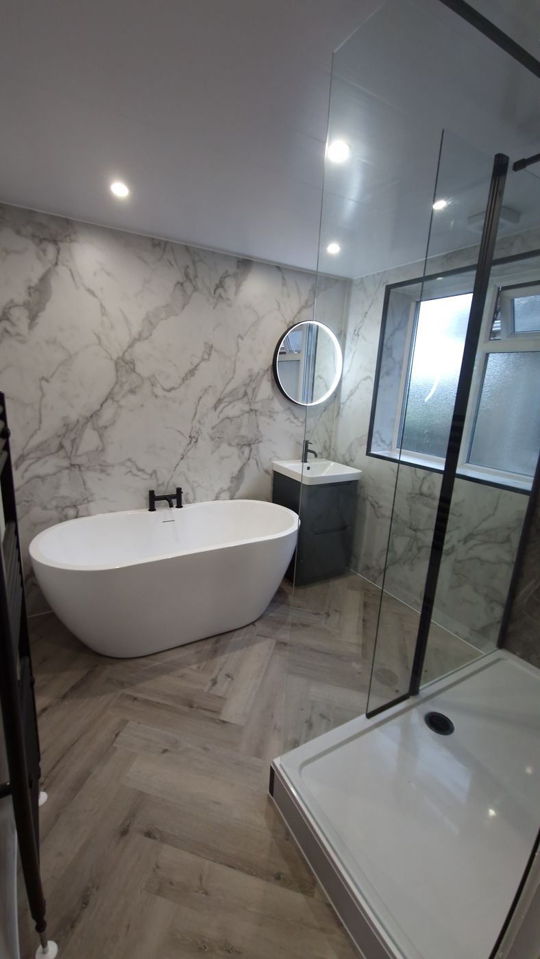 Marble bathroom with freestanding bath, herringbone floor and walk-in shower