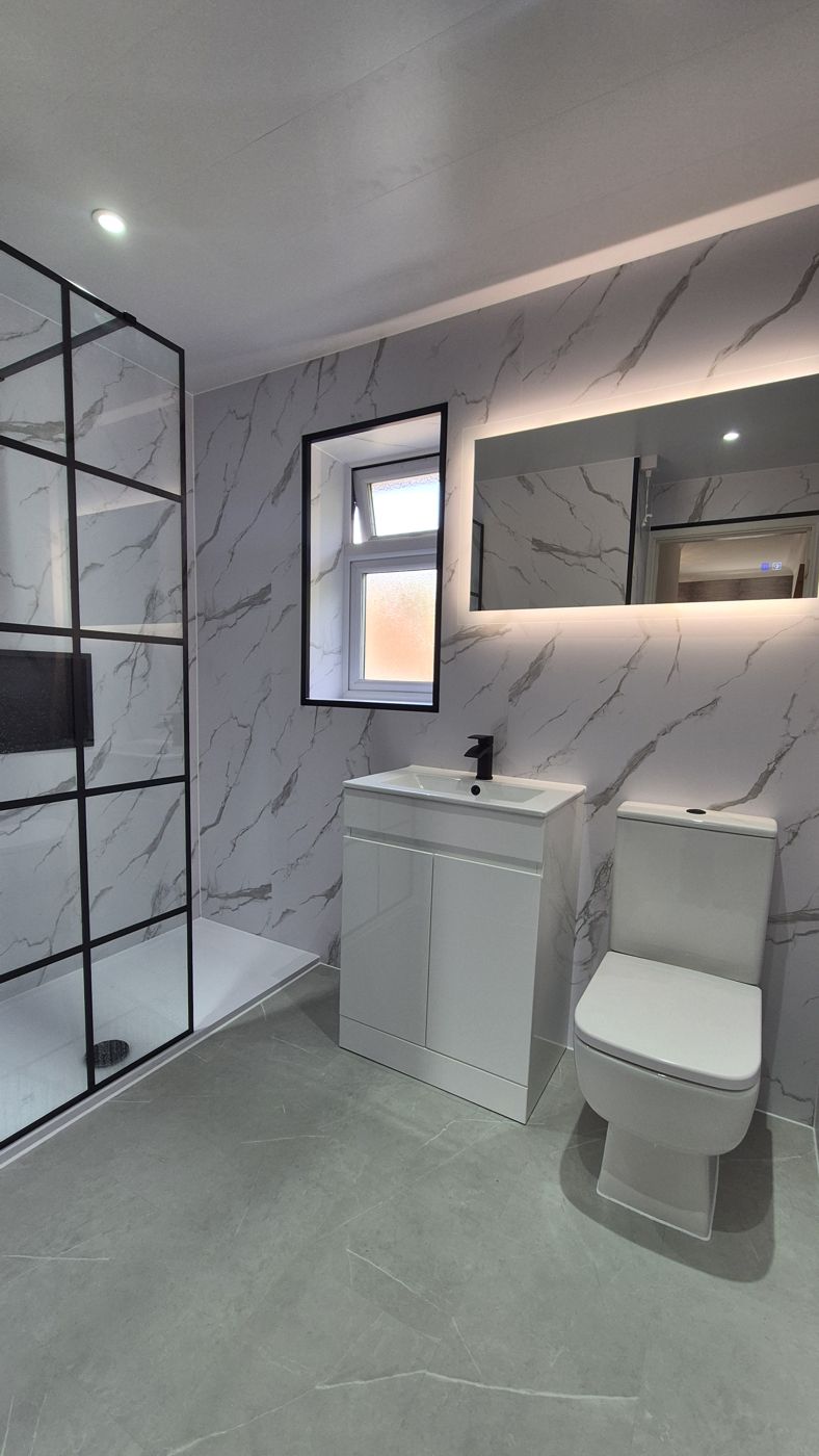 Marble shower room with black grid screen and LED mirror
