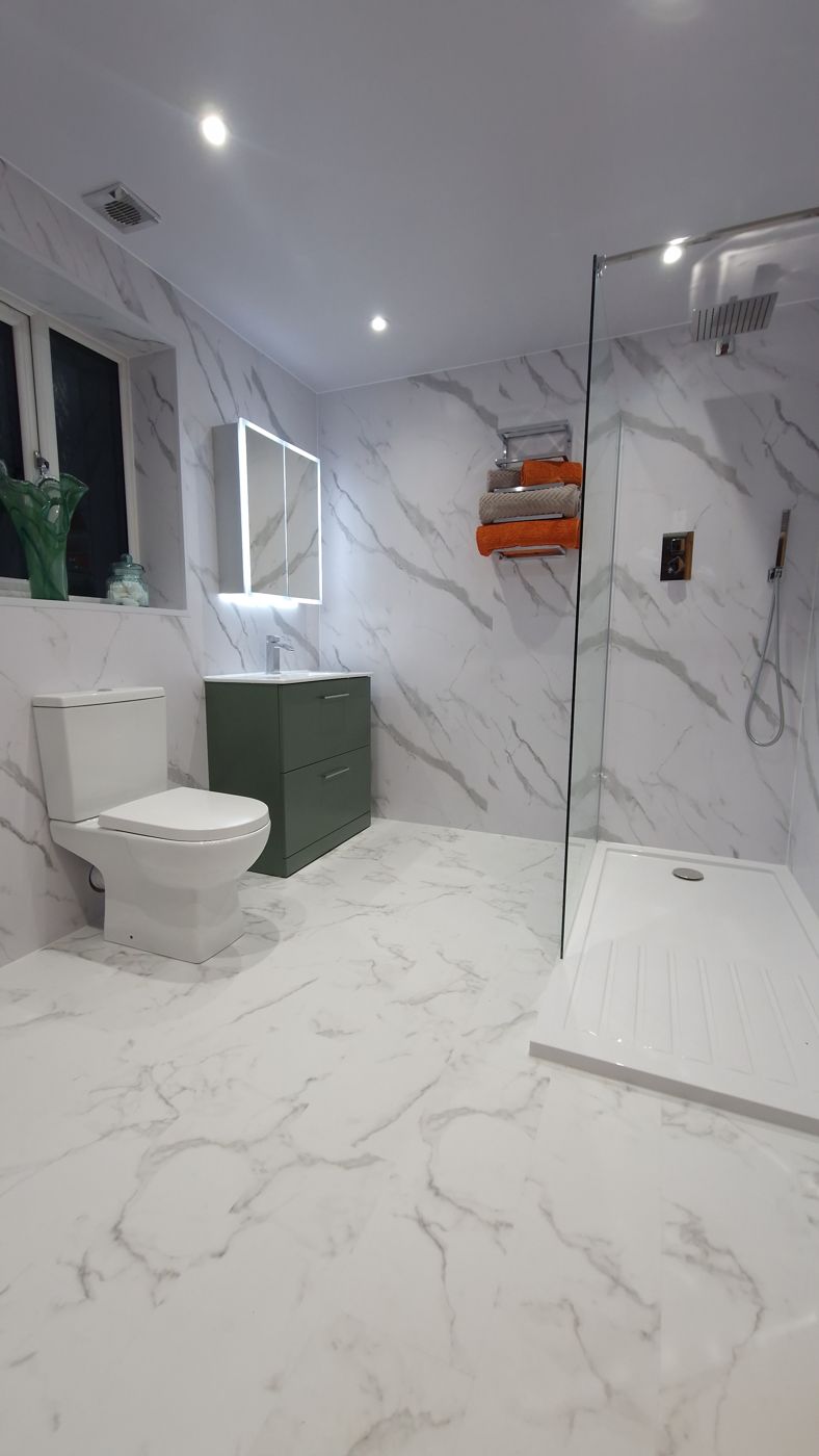 White marble wet room with green vanity