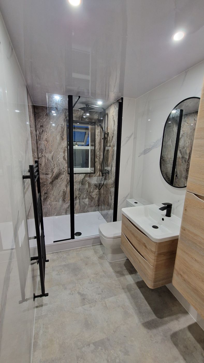 Shower room with brown marble feature wall, oak vanity and black fittings