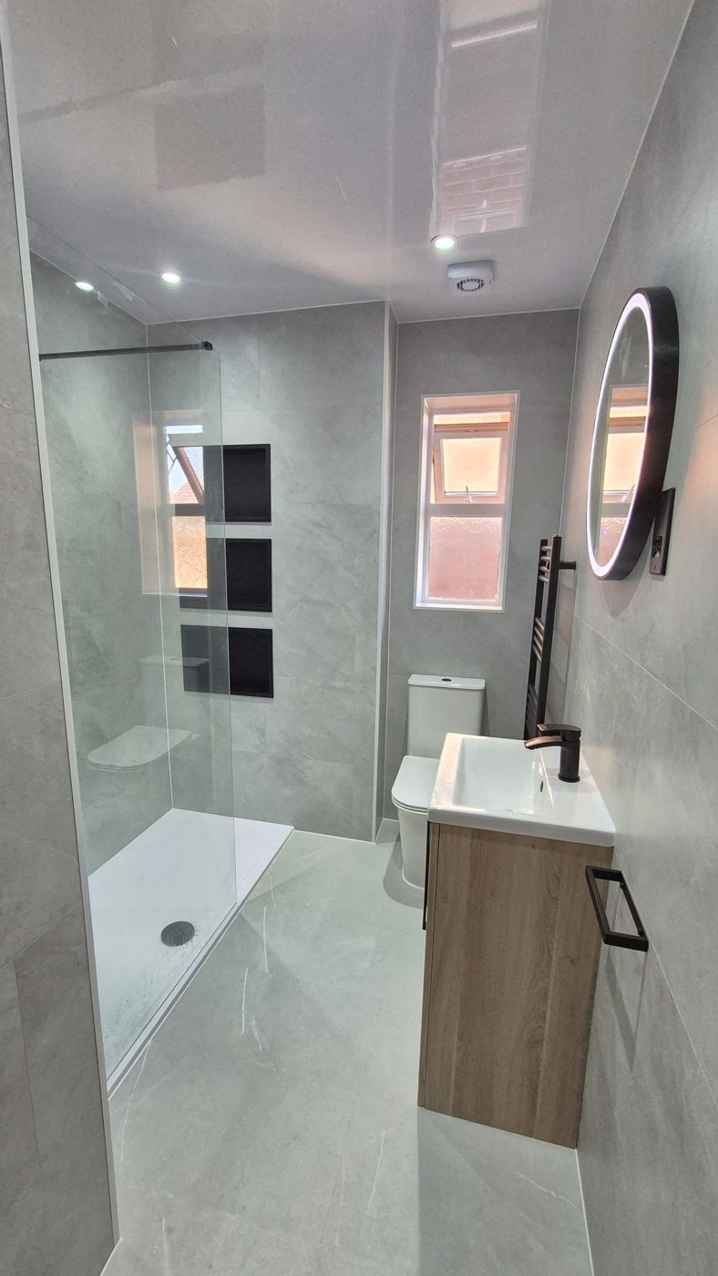 Grey walk-in shower with oak vanity