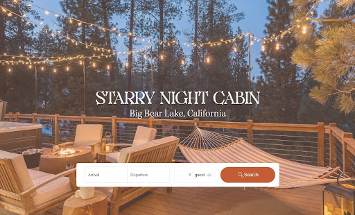 Starry Night Cabin interior — living room, stone fireplace, vaulted ceiling