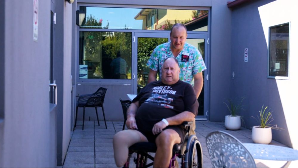 NurseU carer supporting home care client Phil in his wheelchair in Melbourne