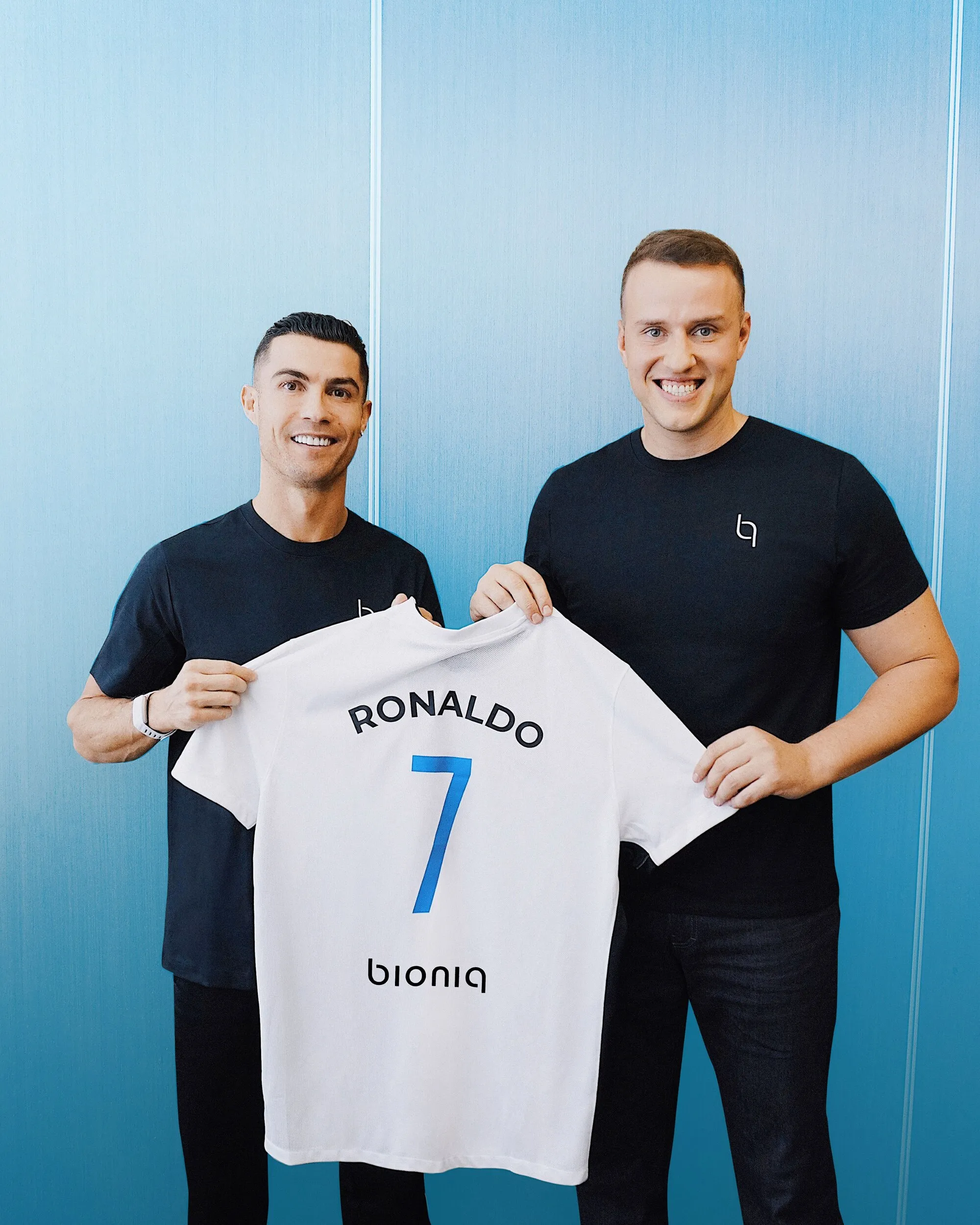 Cristiano Ronaldo holding a BIONIQ football shirt alongside a member of the BIONIQ team