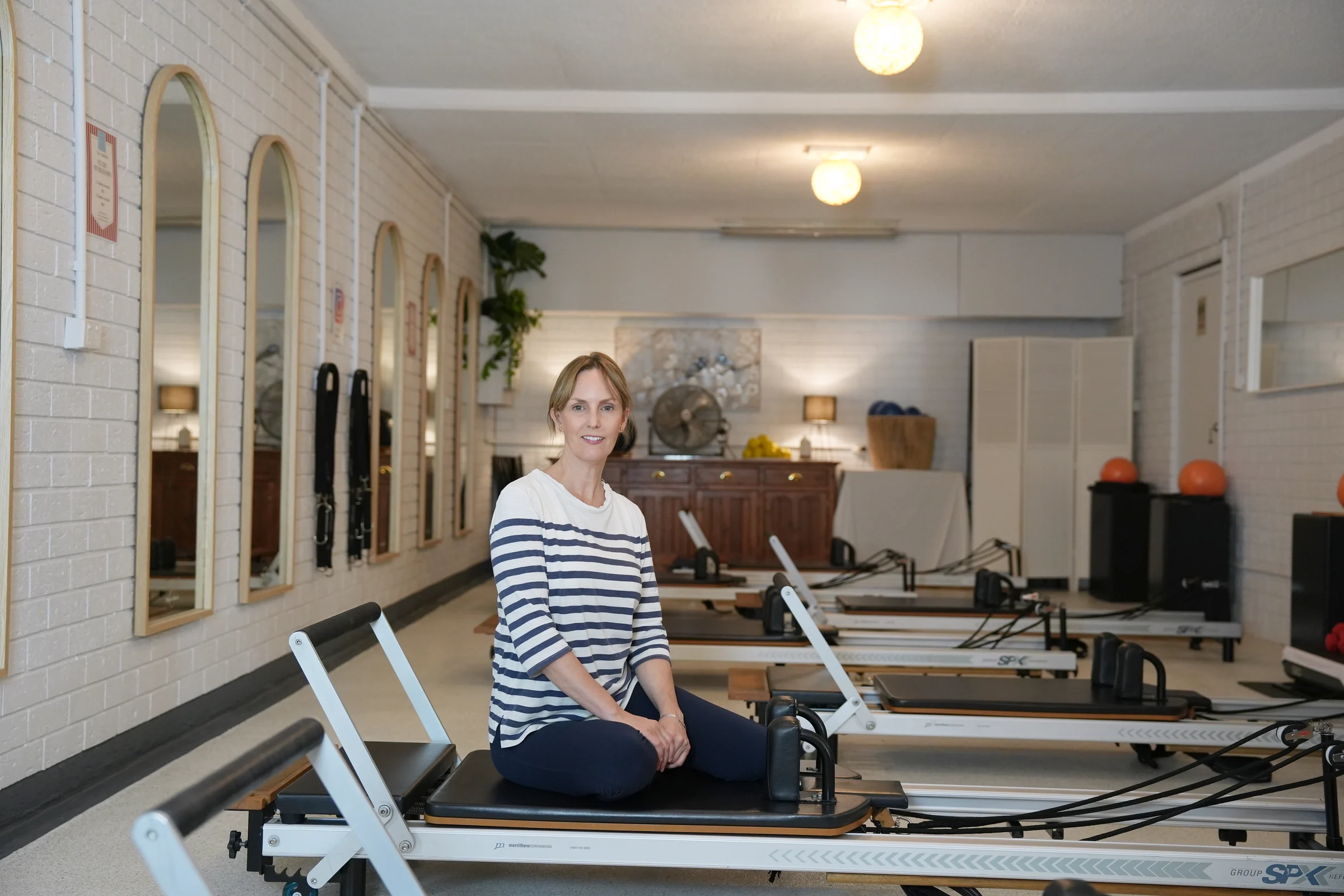 Row of professional Reformer Pilates beds at Pilates at Sarah's studio in Point Clare, kept spotless and ready for small group classes
