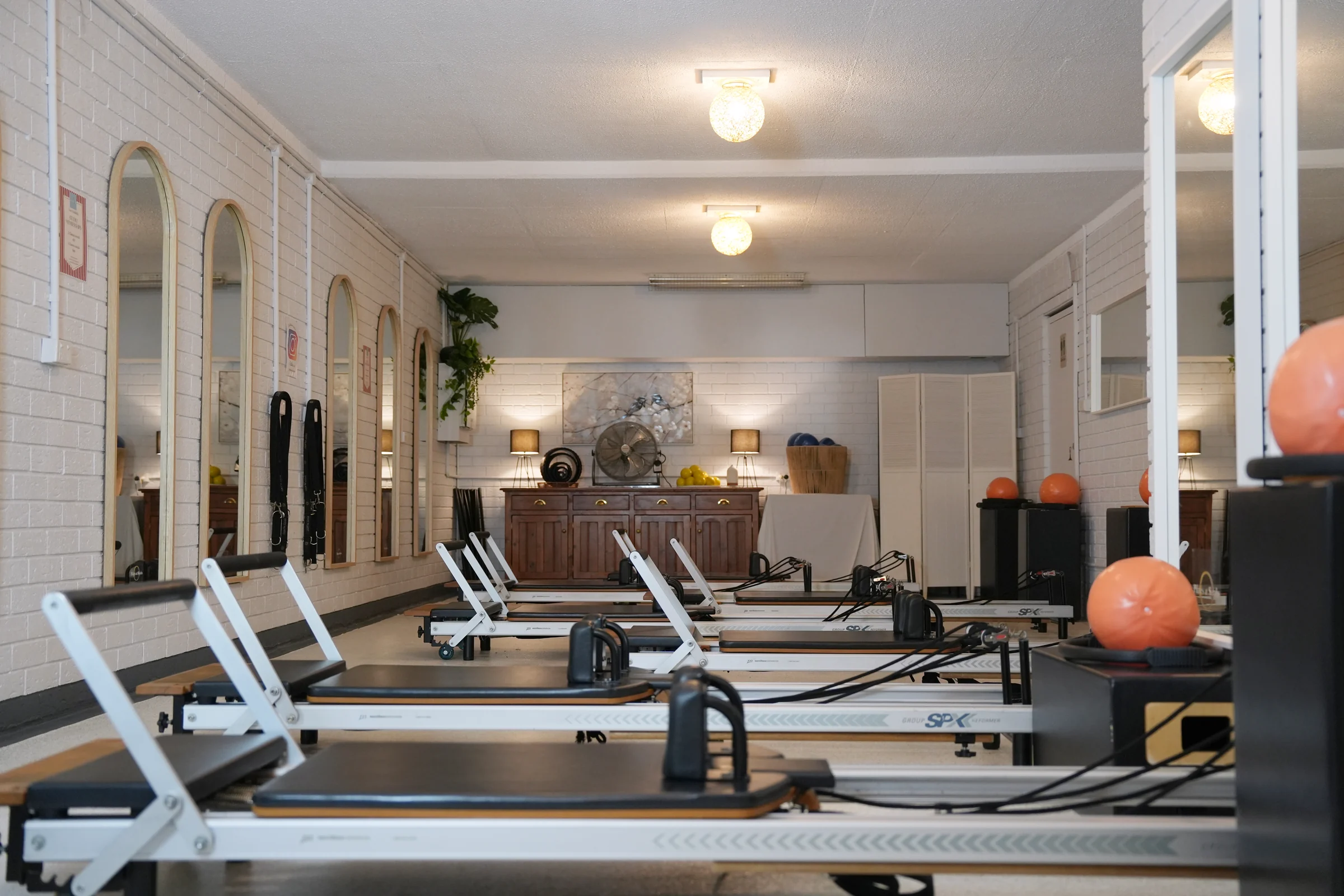 Bright, welcoming Reformer Pilates studio interior at Pilates at Sarah's in Point Clare, featuring premium reformer beds and natural light
