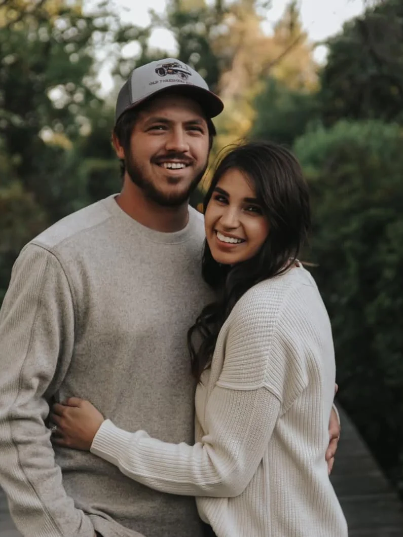 Tanner Krabill and his wife smiling warmly together on a boardwalk trail