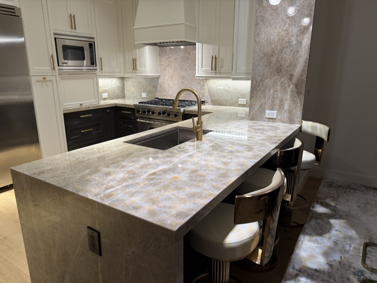 Premium kitchen island with mitered edge and gold fixtures